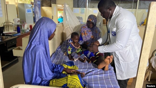 Dr. Japhet Udokwu attends to a child at a treatment center for severely malnourished children in Damaturu, Yobe, Nigeria, Aug. 24, 2022.